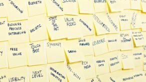 A picture of post it notes featuring words to avoid in business communication, including business jargon.
