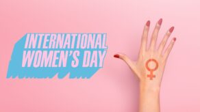 A hand with a pink background and the message 'internation women's day.'